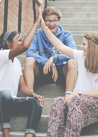 Kids smiling and talking on stairs